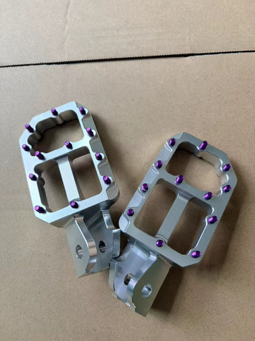 JC Designs wide machined foot pegs with purple titanium traction pins
